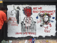 A doctor is painting a mural with slogans inside Kolkata Medical College and Hospital campus condemning the rape and murder of a trainee med...