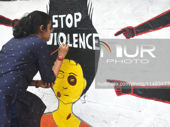 A doctor is painting a mural with slogans inside Kolkata Medical College and Hospital campus condemning the rape and murder of a trainee med...