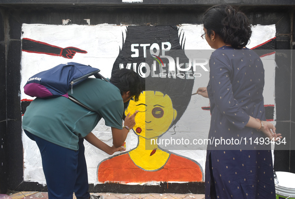 Doctors are painting a mural with slogans inside Kolkata Medical College and Hospital campus condemning the rape and murder of a trainee med...