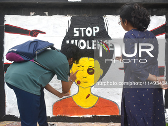 Doctors are painting a mural with slogans inside Kolkata Medical College and Hospital campus condemning the rape and murder of a trainee med...