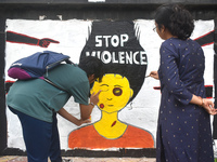 Doctors are painting a mural with slogans inside Kolkata Medical College and Hospital campus condemning the rape and murder of a trainee med...