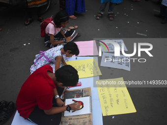 Children are painting and making posters to condemn the rape and murder of a trainee medic at a government-run hospital, in Kolkata, India,...