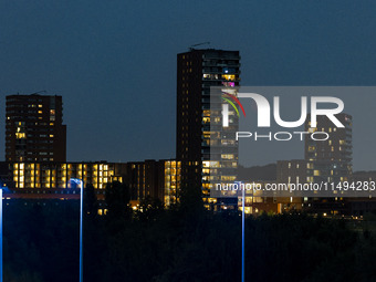 A rare super blue full moon appears rising in the night sky over tall buildings, near the city of Eindhoven in the Netherlands on August 19,...