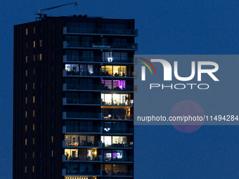 A rare super blue full moon appears rising in the night sky over tall buildings, near the city of Eindhoven in the Netherlands on August 19,...