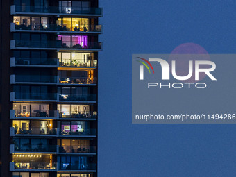 A rare super blue full moon appears rising in the night sky over tall buildings, near the city of Eindhoven in the Netherlands on August 19,...