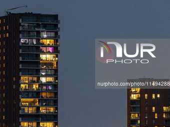 A rare super blue full moon appears rising in the night sky over tall buildings, near the city of Eindhoven in the Netherlands on August 19,...