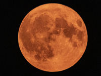 A rare super blue full moon appears rising in the night sky over tall buildings, near the city of Eindhoven in the Netherlands on August 19,...