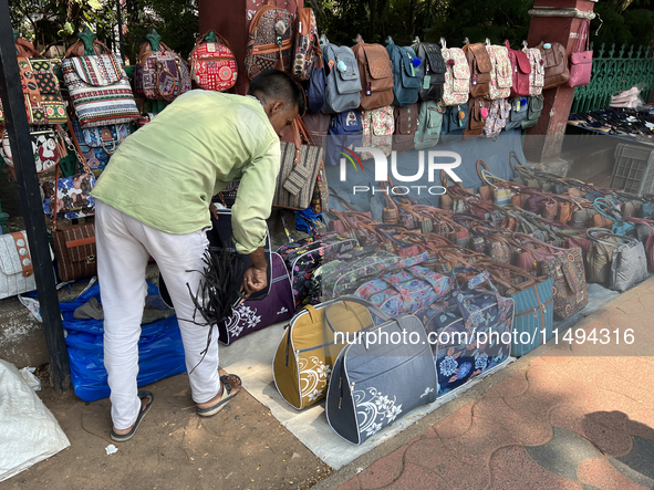 A man is selling bags and handbags along the footpath in Thiruvananthapuram (Trivandrum), Kerala, India, on April 01, 2024. 