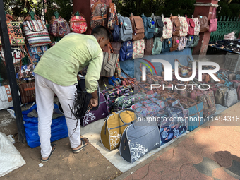 A man is selling bags and handbags along the footpath in Thiruvananthapuram (Trivandrum), Kerala, India, on April 01, 2024. (