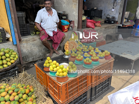 A man is selling mangoes and lemons at the Chalai market in Thiruvananthapuram, Kerala, India, on April 13, 2024. The Chalai Market (Chalai...