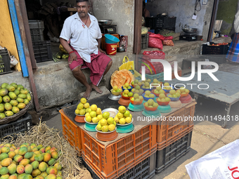 A man is selling mangoes and lemons at the Chalai market in Thiruvananthapuram, Kerala, India, on April 13, 2024. The Chalai Market (Chalai...