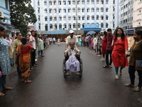 Medical students and doctors are making a human chain during a protest against the rape and murder of a PGT woman doctor at Government-run R...