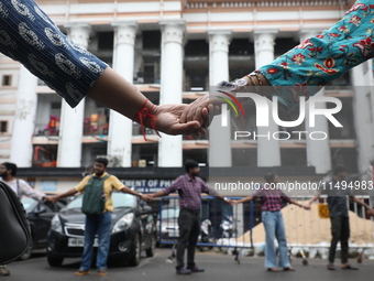 Medical students and doctors are making a human chain during a protest at National Medical College & Hospital against the rape and murder of...