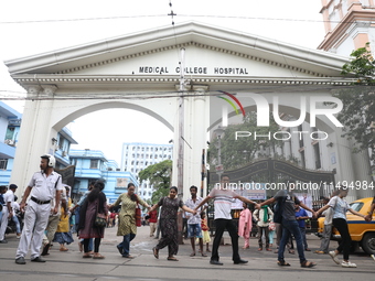 Medical students and doctors are making a human chain outside the National Medical College & Hospital in a protest against the rape and murd...