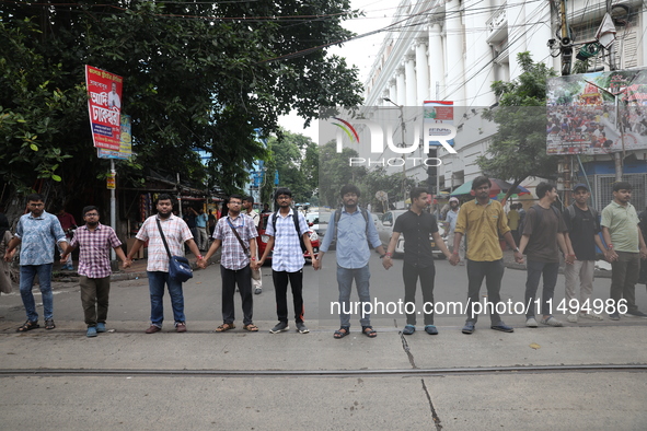 Medical students and doctors are making a human chain during a protest against the rape and murder of a PGT woman doctor at Government-run R...