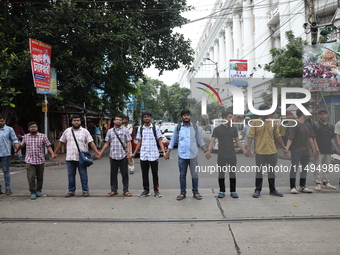 Medical students and doctors are making a human chain during a protest against the rape and murder of a PGT woman doctor at Government-run R...