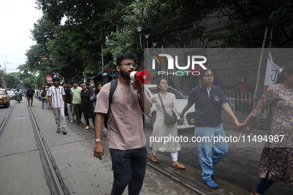 Medical students and doctors are making a human chain during a protest against the rape and murder of a PGT woman doctor at Government-run R...