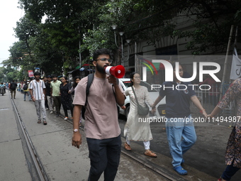 Medical students and doctors are making a human chain during a protest against the rape and murder of a PGT woman doctor at Government-run R...