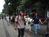 Medical students and doctors are making a human chain during a protest against the rape and murder of a PGT woman doctor at Government-run R...