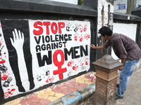 A junior doctor is painting slogans inside National Medical College & Hospital in Kolkata, India, on August 19, 2024, as a protest against t...