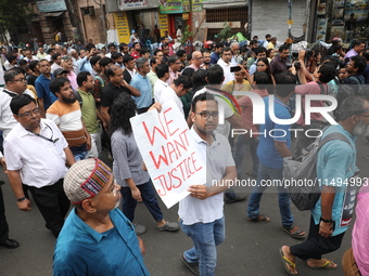 Medical students and doctors are attending a protest rally against the rape and murder of a PGT woman doctor at Government-run R G Kar Medic...