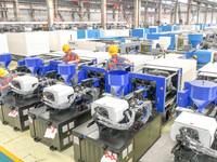 Workers are producing injection molding machines for export at a workshop in Huzhou, Zhejiang province, China, on August 20, 2024. (