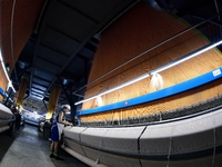 A female textile worker is working at a jacquard loom workshop at Jiangsu Hengyuan Silk Group located in the high-tech zone in Hai 'an, Jian...