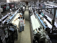 A female textile worker is working at a jacquard loom workshop at Jiangsu Hengyuan Silk Group located in the high-tech zone in Hai 'an, Jian...