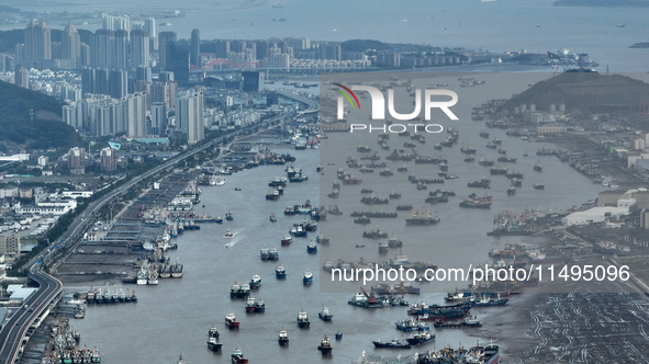 Boats are avoiding Typhoon Jongdari at Shenjiamen fishing port in Zhoushan city, Zhejiang province, China, on August 20, 2024. 