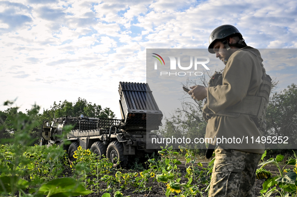 An artilleryman of the 110th Marko Bezruchko Separate Mechanized Brigade who is serving in the Pokrovsk direction is by an RM-70 multiple ro...