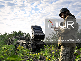 An artilleryman of the 110th Marko Bezruchko Separate Mechanized Brigade who is serving in the Pokrovsk direction is by an RM-70 multiple ro...