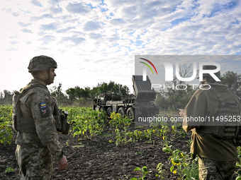 Artillerymen of the 110th Marko Bezruchko Separate Mechanized Brigade who are serving in the Pokrovsk direction are by an RM-70 multiple roc...