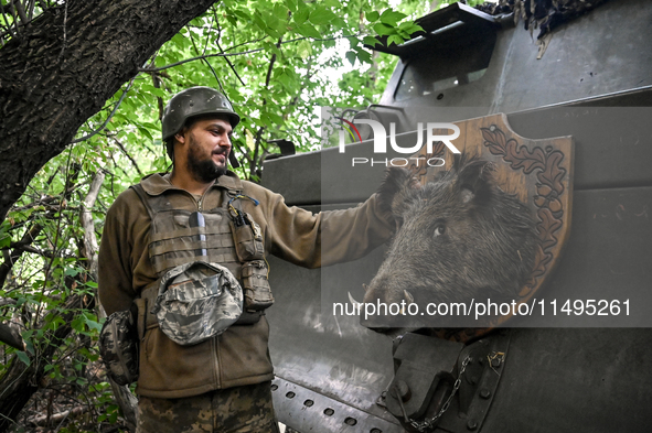 An artilleryman of the 110th Marko Bezruchko Separate Mechanized Brigade who is serving in the Pokrovsk direction is standing by an RM-70 mu...