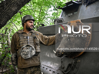 An artilleryman of the 110th Marko Bezruchko Separate Mechanized Brigade who is serving in the Pokrovsk direction is standing by an RM-70 mu...