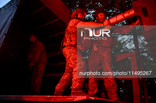 Artillerymen of the 110th Marko Bezruchko Separate Mechanized Brigade who serve in the Pokrovsk direction are loading an RM-70 multiple rock...