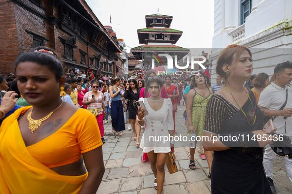 Members of the sexual minority LGBTIQ+ group of Nepal are walking past the Kumari Ghar (left) and Gaddhi Baithak (right) located in Kathmand...