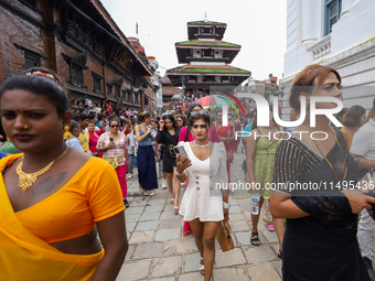 Members of the sexual minority LGBTIQ+ group of Nepal are walking past the Kumari Ghar (left) and Gaddhi Baithak (right) located in Kathmand...