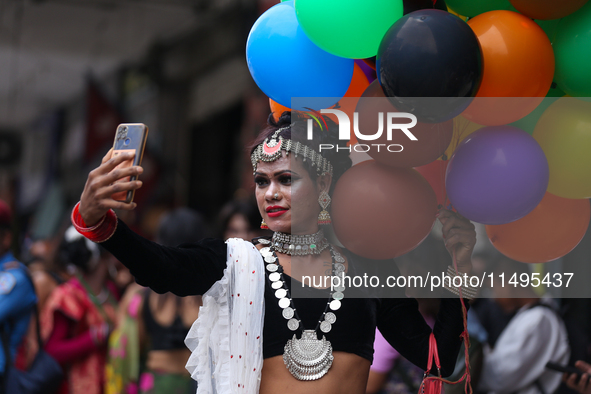 A member of the sexual minority LGBTIQ+ group of Nepal is taking a selfie during the Gaijatra (Pride) parade in Kathmandu, Nepal, on August...