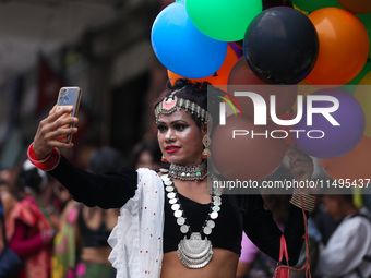 A member of the sexual minority LGBTIQ+ group of Nepal is taking a selfie during the Gaijatra (Pride) parade in Kathmandu, Nepal, on August...