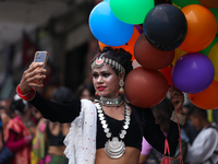 A member of the sexual minority LGBTIQ+ group of Nepal is taking a selfie during the Gaijatra (Pride) parade in Kathmandu, Nepal, on August...