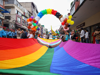 Members of the sexual minority LGBTIQ+ group of Nepal are unfurling the rainbow flag, holding its edges before the formal start of the Gaija...