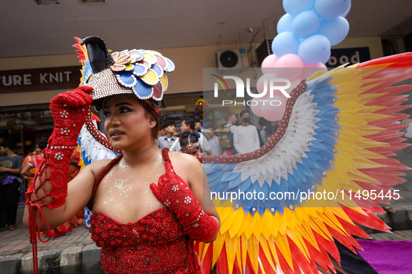 A member of the sexual minority LGBTIQ+ group of Nepal is fixing a mask during the Gaijatra (Pride) parade in Kathmandu, Nepal, on August 20...