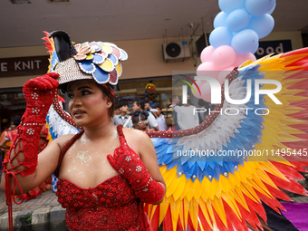 A member of the sexual minority LGBTIQ+ group of Nepal is fixing a mask during the Gaijatra (Pride) parade in Kathmandu, Nepal, on August 20...