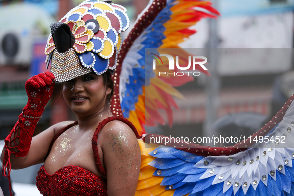 A member of the sexual minority LGBTIQ+ group of Nepal is fixing a mask during the Gaijatra (Pride) parade in Kathmandu, Nepal, on August 20...