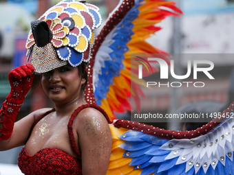 A member of the sexual minority LGBTIQ+ group of Nepal is fixing a mask during the Gaijatra (Pride) parade in Kathmandu, Nepal, on August 20...