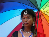 A member of the sexual minority LGBTIQ+ group of Nepal is wearing a rainbow-colored umbrella during the Gaijatra (Pride) parade in Kathmandu...