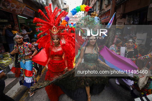 Members of the sexual minority LGBTIQ+ group of Nepal are dancing as they walk through the alleyways during the Gaijatra (Pride) parade in K...