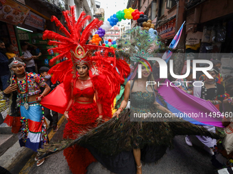 Members of the sexual minority LGBTIQ+ group of Nepal are dancing as they walk through the alleyways during the Gaijatra (Pride) parade in K...