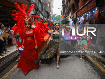 Members of the sexual minority LGBTIQ+ group of Nepal are dancing as they walk through the alleyways during the Gaijatra (Pride) parade in K...