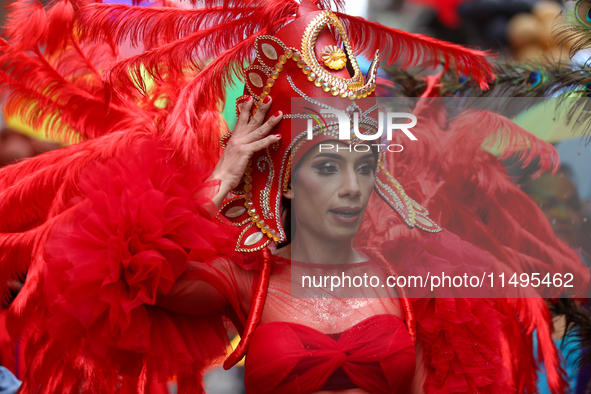 A member of the sexual minority LGBTIQ+ group of Nepal is fixing a mask during the Gaijatra (Pride) parade in Kathmandu, Nepal, on August 20...